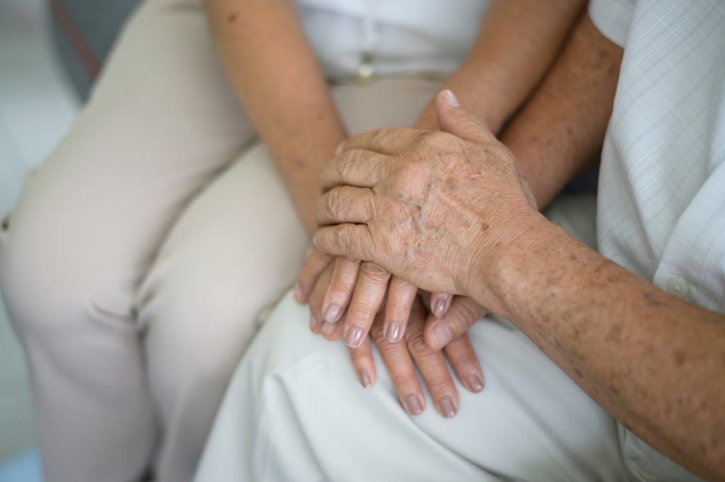 Old people holding hands each other